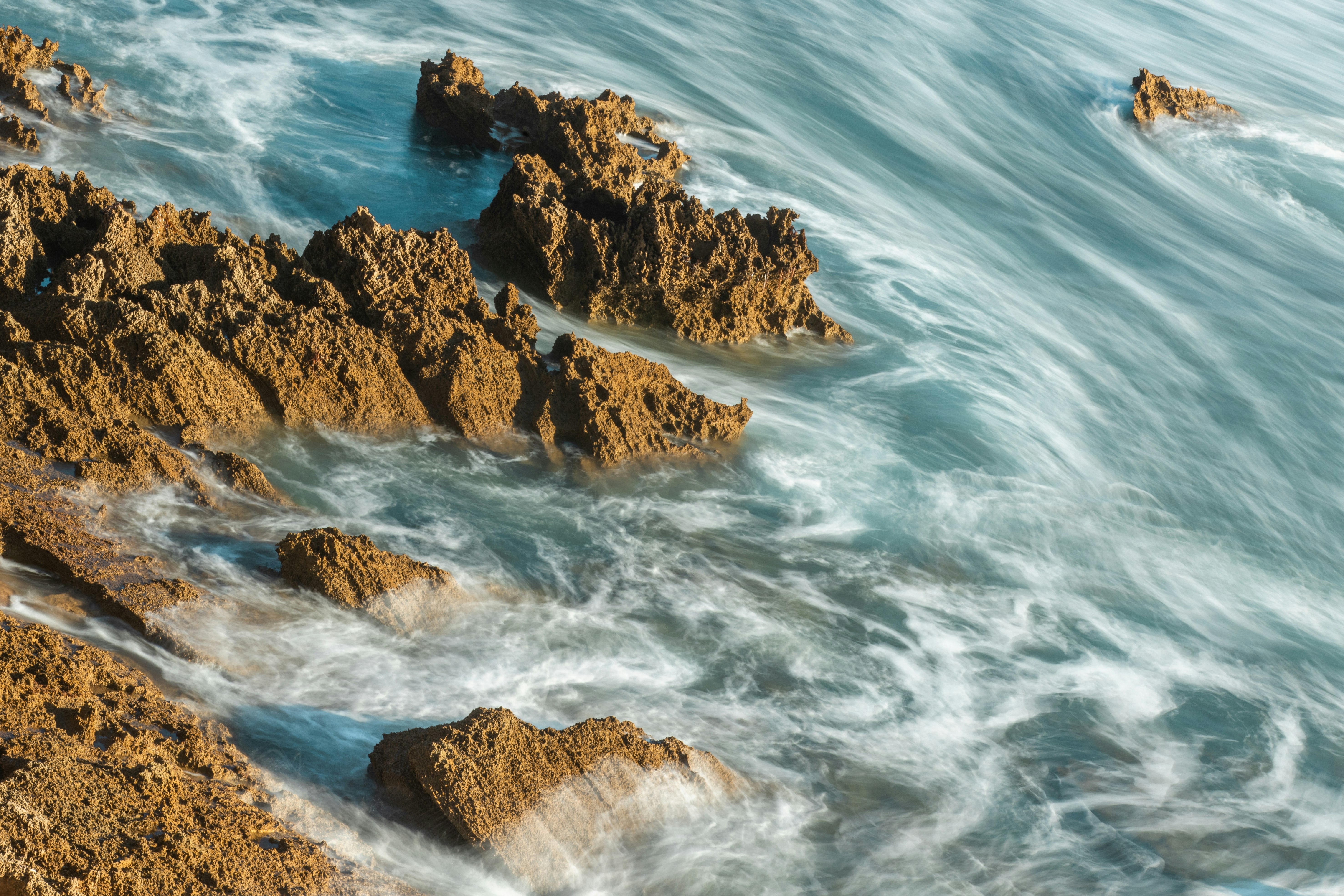 brown rock formation on sea during daytime